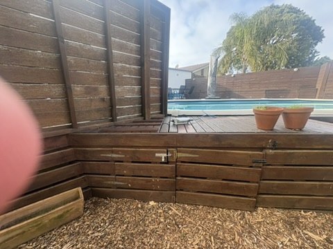Timber structures adjoining a deck and swimming-pool area